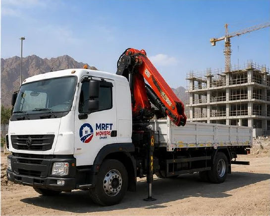 HIAB crane truck lifting palletised equipment in Oman